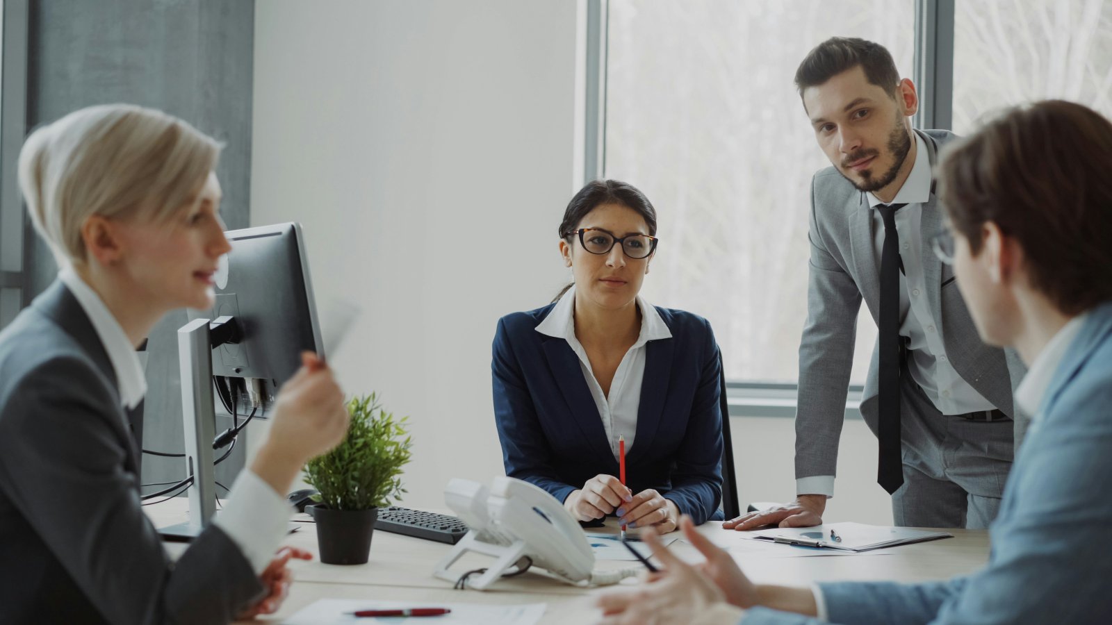 Colleagues of different backgrounds working through a plan in a meeting